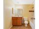 Bright bathroom featuring a sink vanity, toilet, and bathtub with tile surround at 6052 Westgate Dr # 204, Orlando, FL 32835
