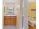 Well-lit bathroom with a vanity and mirror and a toilet and bathtub visible through an open door at 6052 Westgate Dr # 204, Orlando, FL 32835