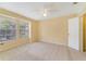 Bright bedroom with a ceiling fan, natural light, and spacious closet with neutral colored walls and carpet at 6052 Westgate Dr # 204, Orlando, FL 32835