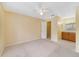 Spacious bedroom featuring neutral carpeting, a ceiling fan, and access to a closet and bathroom at 6052 Westgate Dr # 204, Orlando, FL 32835