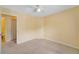 Bedroom featuring neutral carpet and access to a bathroom at 6052 Westgate Dr # 204, Orlando, FL 32835