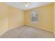 Bedroom featuring neutral carpet, a window, and a view of the neighborhood at 6052 Westgate Dr # 204, Orlando, FL 32835