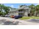 This is an exterior view of the condo building, showcasing its architecture, surrounding greenery, and parking area for residents at 6052 Westgate Dr # 204, Orlando, FL 32835