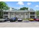 The apartment building has a lush green roof, a parking lot, and balconies overlooking the lot at 6052 Westgate Dr # 204, Orlando, FL 32835