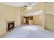 Open living space with a fireplace flowing into a kitchen featuring white appliances and wood cabinets at 6052 Westgate Dr # 204, Orlando, FL 32835