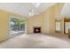 Bright living area with sliding doors to a balcony, a fireplace, and open access to the kitchen at 6052 Westgate Dr # 204, Orlando, FL 32835