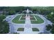 Aerial view of a manicured traffic circle with clock tower and surrounding residential area at 6333 Schoolhouse Pond Rd, Winter Garden, FL 34787