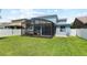 Fully fenced in backyard with a screened lanai is perfect for outdoor enjoyment at 6333 Schoolhouse Pond Rd, Winter Garden, FL 34787