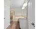 Bathroom with a double vanity, shower, soaking tub, and neutral tile at 6333 Schoolhouse Pond Rd, Winter Garden, FL 34787