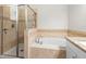 Bathroom features a large soaking tub and glass-enclosed shower at 6333 Schoolhouse Pond Rd, Winter Garden, FL 34787