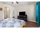 Spacious bedroom with wood floors, large TV and walk in closet at 6333 Schoolhouse Pond Rd, Winter Garden, FL 34787