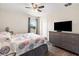 Comfortable bedroom features wood floors and a large dresser with a television at 6333 Schoolhouse Pond Rd, Winter Garden, FL 34787