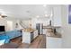 Open-concept kitchen and living area showcasing stainless steel appliances and a breakfast bar at 6333 Schoolhouse Pond Rd, Winter Garden, FL 34787
