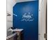 Cozy laundry room with a washing machine and dryer, decorated with a charming laundry-themed wall decal at 6333 Schoolhouse Pond Rd, Winter Garden, FL 34787