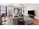 Spacious living room with hardwood floors, comfortable seating, and a view of the backyard at 6333 Schoolhouse Pond Rd, Winter Garden, FL 34787