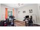 Well-lit home office featuring hardwood floors and ample space for multiple workstations at 6333 Schoolhouse Pond Rd, Winter Garden, FL 34787