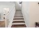 Staircase with wooden steps and white banister leads to upper level at 6333 Schoolhouse Pond Rd, Winter Garden, FL 34787