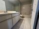 Bathroom with tiled shower/tub, a large mirror, a white vanity, and tiled floors at 652 Roaring Dr # 234, Altamonte Springs, FL 32714