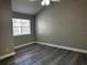 This bedroom features new gray paint, modern floors, a ceiling fan, and a window with blinds at 652 Roaring Dr # 234, Altamonte Springs, FL 32714