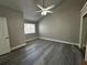 A minimalist bedroom with vaulted ceilings, gray walls, modern ceiling fan and light gray vinyl floors at 652 Roaring Dr # 234, Altamonte Springs, FL 32714