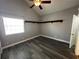 This bedroom features new gray paint, modern floors, a ceiling fan, and a small corner shelf at 652 Roaring Dr # 234, Altamonte Springs, FL 32714