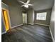 The bedroom features a window, door leading to a bathroom, and dark gray vinyl floors at 652 Roaring Dr # 234, Altamonte Springs, FL 32714