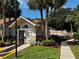 Exterior view of community office building with lush landscaping, including palm trees and flowering plants at 652 Roaring Dr # 234, Altamonte Springs, FL 32714