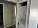 Hallway with a closet that contains a stackable washer and dryer unit at 652 Roaring Dr # 234, Altamonte Springs, FL 32714
