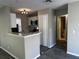 A modern kitchen with stainless steel appliances, white cabinets, and a gray accent wall and flooring at 652 Roaring Dr # 234, Altamonte Springs, FL 32714