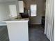 View of the kitchen with marble counter tops, modern sink and adjacent front door at 652 Roaring Dr # 234, Altamonte Springs, FL 32714