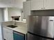 Kitchen view overlooking the fireplace and large living area with many windows and hardwood floor at 652 Roaring Dr # 234, Altamonte Springs, FL 32714