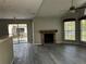 Living room offering access to a balcony, featuring a brick fireplace and wood-look floors at 652 Roaring Dr # 234, Altamonte Springs, FL 32714