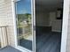 View from balcony through sliding glass door to open concept living room and kitchen at 652 Roaring Dr # 234, Altamonte Springs, FL 32714