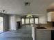 An open living room with large windows, brick fireplace and modern hardwood flooring at 652 Roaring Dr # 234, Altamonte Springs, FL 32714