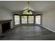 Spacious living room with a brick fireplace, large windows, ceiling fan and modern hardwood floors at 652 Roaring Dr # 234, Altamonte Springs, FL 32714