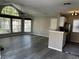Open-concept space showcasing a modern kitchen bar and a bright living area with large windows at 652 Roaring Dr # 234, Altamonte Springs, FL 32714