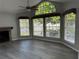 Bright living room with a ceiling fan, three large windows, grey walls, and a fireplace at 652 Roaring Dr # 234, Altamonte Springs, FL 32714