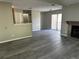 Open-concept living space featuring wood-look floors, a fireplace, and access to the balcony at 652 Roaring Dr # 234, Altamonte Springs, FL 32714