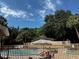 Community pool area featuring multiple chairs and tables, as well as views of the neighboring buildings at 652 Roaring Dr # 234, Altamonte Springs, FL 32714