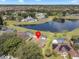 Aerial view of a home with a screened-in pool overlooking a serene lake at 703 Sunridge Woods Blvd, Davenport, FL 33837