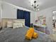 Serene bedroom with neutral tones, decorative lighting, and a comfortable workspace at 703 Sunridge Woods Blvd, Davenport, FL 33837