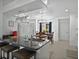 Bright and open kitchen featuring modern island with seating and dining area at 703 Sunridge Woods Blvd, Davenport, FL 33837