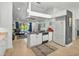 Modern kitchen with white cabinetry, black appliances, and an open floor plan at 703 Sunridge Woods Blvd, Davenport, FL 33837