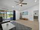 Comfortable living room with sliding glass doors that lead to outdoor pool area at 703 Sunridge Woods Blvd, Davenport, FL 33837