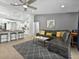 Spacious living room with a ceiling fan, open floor plan, and seamless flow to the kitchen at 703 Sunridge Woods Blvd, Davenport, FL 33837
