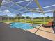 Beautiful screened-in pool and spa offer a relaxing backyard retreat with lovely views at 703 Sunridge Woods Blvd, Davenport, FL 33837