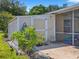 Exterior view of the shed and screen porch, providing additional storage and covered outdoor space at 703 Sunridge Woods Blvd, Davenport, FL 33837
