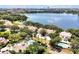 Scenic aerial view of homes near a large lake, community pool, and lush greenery at 7521 Bay Port Rd # 12, Orlando, FL 32819