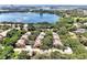 Aerial view showing homes near a scenic lake surrounded by lush trees at 7521 Bay Port Rd # 12, Orlando, FL 32819