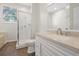 Bathroom with granite countertop, white cabinets, glass shower, and ample natural light at 7521 Bay Port Rd # 12, Orlando, FL 32819
